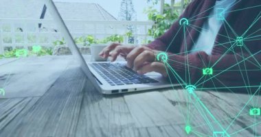 Animation of network of connections with social media icons over caucasian senior woman using laptop. social media and communication concept digitally generated video.