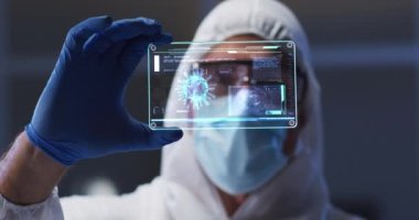 Animation of orange virus cells over caucasian male lab worker in safety clothes with digital card. Health, medicine, biology, science and covid 19 pandemic concept digitally generated video.
