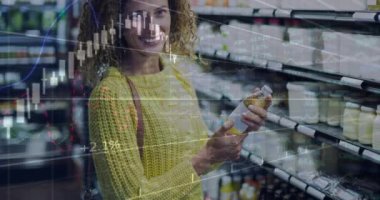 Animation of data processing over happy caucasian woman in shop. Global business, shopping and digital interface concept digitally generated video.