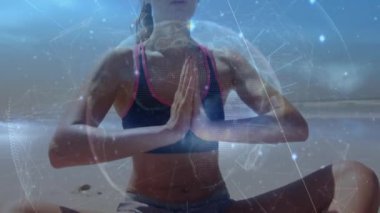 Animation of globe with network of connections over caucasian woman meditating at beach. Global sport, computing and digital interface concept digitally generated video.