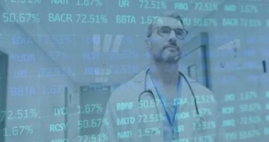 Animation of financial data over caucasian male doctor walking. Health, medicine and finance concept digitally generated video.