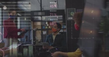 Statistical data processing over diverse office colleagues wearing face masks discussing at office. Business data and analytics concept