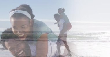 Animation of happy african american couple having fun on beach. Holidays, vacations, love, relationship and relax concept digitally generated video.