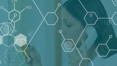 Animation of chemical formulas over biracial female doctor talking by phone. Health, science and medicine concept digitally generated video.