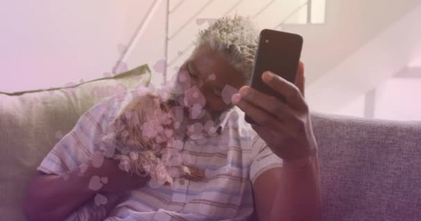 Animation Falling Hearts African American Senior Man Using Smartphone International — Vídeo de stock