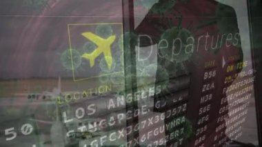 Animation of timetable and virus cells over caucasian man talking on smartphone at airport. Global covid 19 pandemic and digital interface concept digitally generated video.