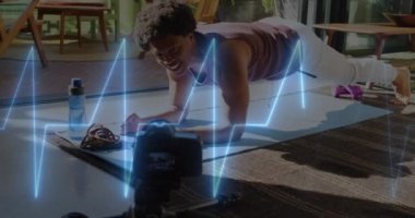 Animation of neon heart rate over african american man doing plank. Sport, fitness, active lifestyle and life functions monitoring concept digitally generated video.