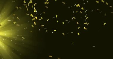 Animation of confetti falling over yellow light on black background. Party, music and entertainment concept digitally generated video.