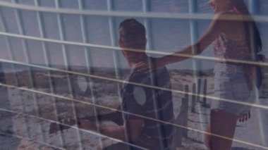 Animation of net over happy caucasian couple on beach. Holidays, vacations, love, relationship and relax concept digitally generated video.