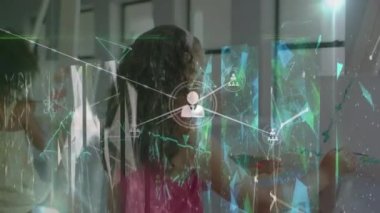 Animation of connections over diverse girls at school during painting lessons. School, education, learning and connections concept digitally generated video.