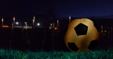 Animation of glowing lights at nights sky over football ball. World cup soccer concept digitally generated video.