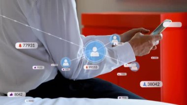 Animation of media icons over biracial businessman using smartphone. Global business and digital interface concept digitally generated video.