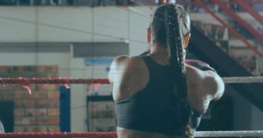 Animation of data processing over caucasian woman boxing at gym. Global sport, computing and digital interface concept digitally generated video.