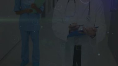 Animation of network of connections and light trails over diverse doctors. Global medicine, healthcare and digital interface concept digitally generated video.