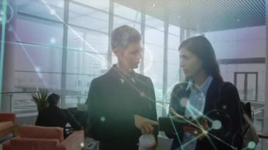 Animation of network of connections over diverse business people talking. Global business and digital interface concept digitally generated video.