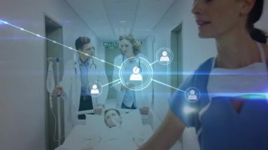Animation of network of connections with icons and light trails over diverse doctors and patient. Global medicine, healthcare and digital interface concept digitally generated video.