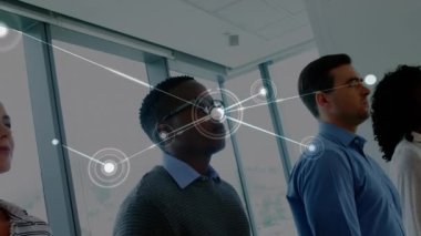 Animation of network of connections over group of diverse office colleagues walking at office. Global networking and business technology concept