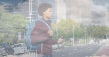 Animation of clouds over african american businessman walking. Global business and digital interface concept digitally generated video.