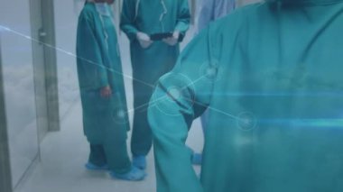 Animation of network of connections over biracial male surgeon in face mask. Health, medicine, connections and technology concept digitally generated video.