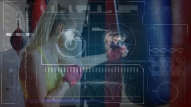 Animation of data processing over caucasian female boxer punching at gym. Global sport and digital interface concept digitally generated video.