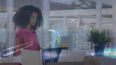 Animation of data processing over biracial woman with laptop in office. Business, data processing and technology concept digitally generated video.