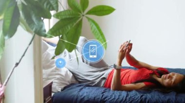 Animation of network of connections with icons over asian woman using smartphone. Social media and digital interface concept digitally generated video.