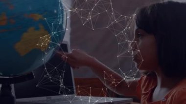 Animation of network of connections over caucasian girl touching a globe model at school. School and education technology concept