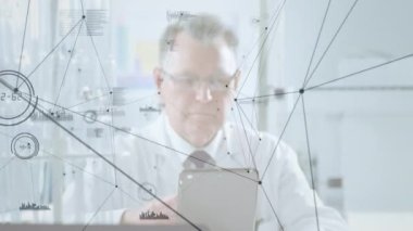 Animation of connections over senior caucasian doctor with tablet. Health, medicine and connections concept digitally generated video.