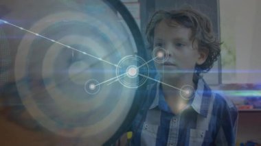 Animation of network of connections over caucasian boy touching a globe model at school. School and education technology concept