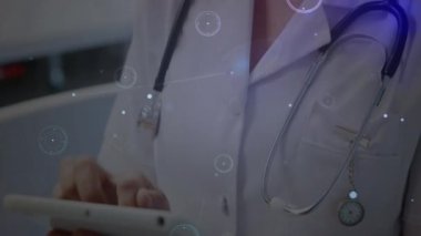 Animation of glowing network of connections over caucasian female doctor using digital tablet. Medical healthcare and technology concept