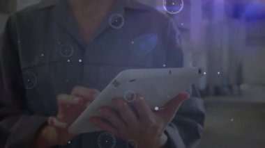 Animation of network of connections over caucasian female worker using tablet. Global business and digital interface concept digitally generated video.