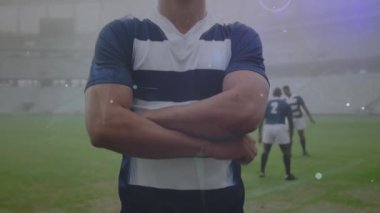 Animation of network of connections over portrait of caucasian male rugby player at sports field. Global networking and sports technology concept