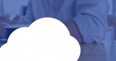 Animation of clouds with icons over hands using laptop. Global business and digital interface concept digitally generated video.