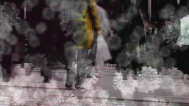 Animation of virus cells over walking people. Health and covid 19 pandemic concept digitally generated video.