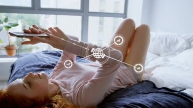 Animation of network of connections with icons over caucasian woman using smartphone. Social media and digital interface concept digitally generated video.