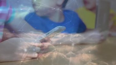 Animation of network of connections against mid section of girl using digital tablet at school. Global networking and education technology concept