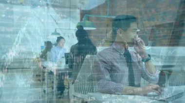 Animation of bar graph over asian employee working on computer with colleagues in office. Digital composite, multiple exposure, business, data, technology, development, finance.