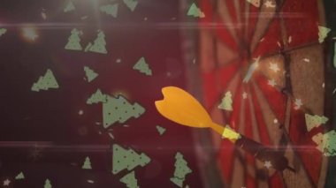 Animation of multiple christmas tree icons falling over close up of a yellow arrow on dart board. Casino and gambling concept