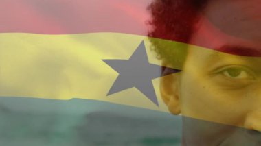 Animation of flag of ghana over african american man at beach. National flags, patriotism and holiday concept digitally generated video.