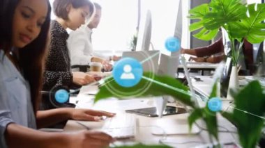 Animation of network of connections with icons over diverse business people at office. Global business, connections and digital interface concept digitally generated video.