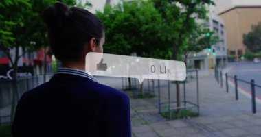 Animation of social media like notification over biracial woman walking in street using smartphone. Global communication network, business and social media concept digitally generated video.
