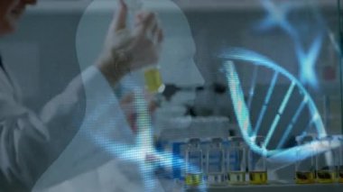 Animation of dna strands over caucasian male scientist. Global science, computing and digital interface concept digitally generated video.