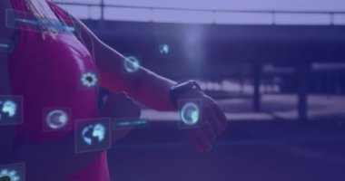 Animation of digital screens with data over hands of african american woman using smartwatch. Data processing, digital interface and technology concept digitally generated video.