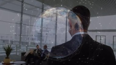 Animation of globe with data processing over diverse business people. Global business, computing and digital interface concept digitally generated video.