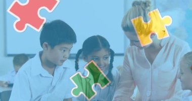 Animation of puzzle pieces over diverse schoolchildren and teacher. autism awareness month and celebration concept digitally generated video.