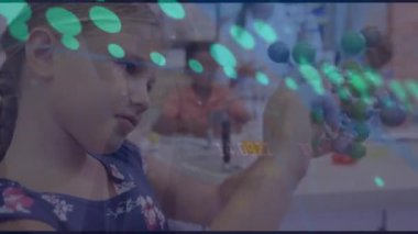 Animation of dots and numbers moving over caucasian girl with molecular model in classroom. Digital composite, multiple exposure, learning, education, science, childhood and school concept.