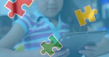 Animation of puzzle pieces over biracial schoolgirlusing tablet. autism awareness month and celebration concept digitally generated video.