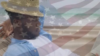 Animation of happy african american man over flag of usa. American patriotism and nation diversity concept digitally generated video.