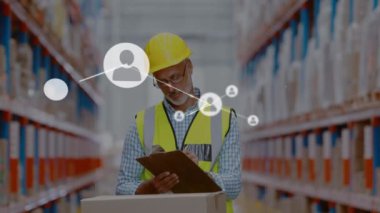 Animation of networks of connection with people icons over caucasian man working in warehouse. Global shipping, business, connections, networks and data processing concept digitally generated video.