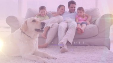 Spot of light against caucasian family and their dog at home. national pet month awareness concept